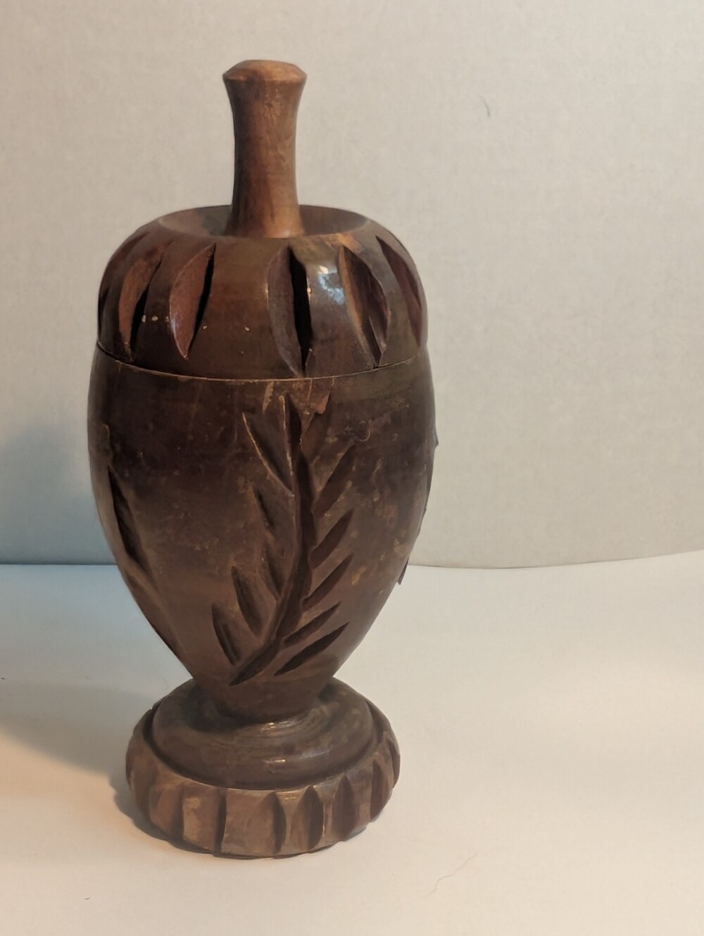 Large turned carved wood lidded jar urn with a detailed leaf pattern.